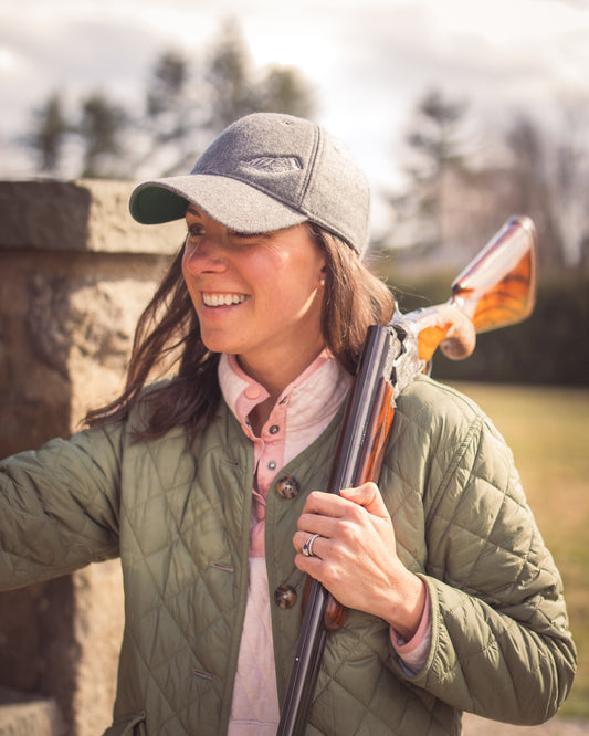 Isabelle Hunter & Co celebrates women in fieldsports – an elegant shooter takes aim, dressed in high-quality, tailored fieldwear.